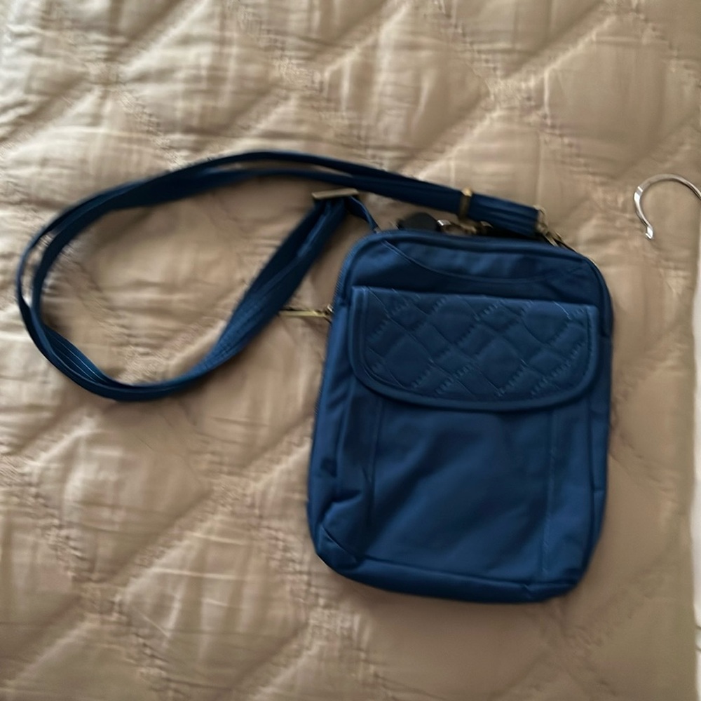 Traveling Blue cross body anti theft travel bag.